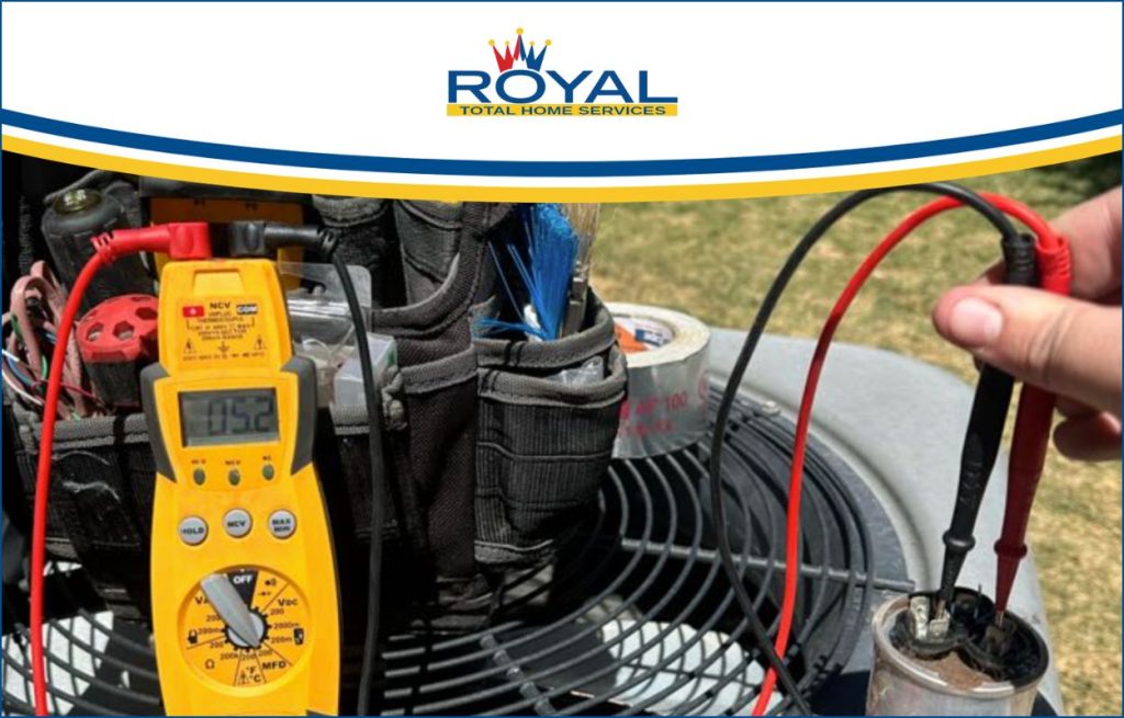 A Royal HVAC tech fixing the AC unit.