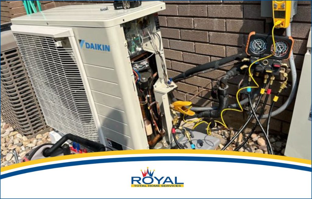A heat pump being worked on on the side of the house