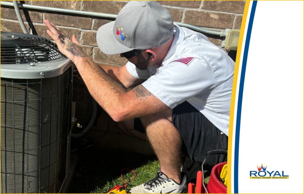 A Royal HVAC tech checking an AC unit.