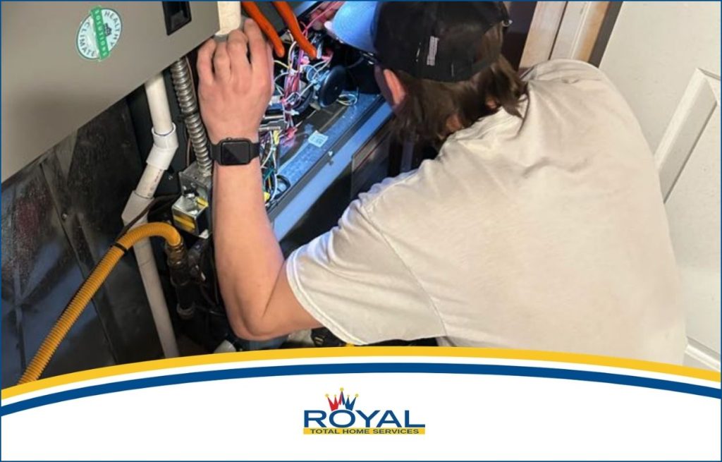 A Royal HVAC tech servicing a AC unit.